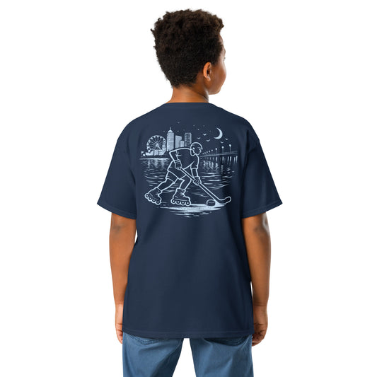 Youth midnight roller hockey t-shirt navy blue back view worn by a boy with baby blue waterfront roller hockey graphic featuring a skater, city skyline, ferris wheel, pier, moon, and water reflections.