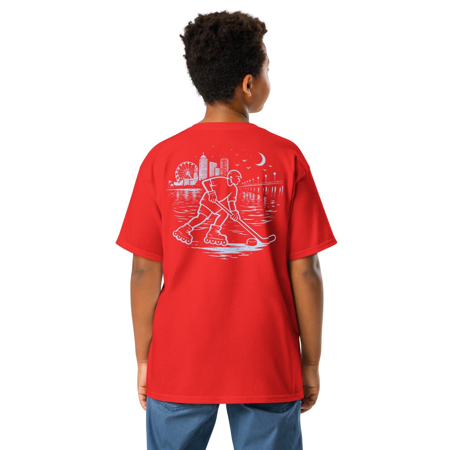 Youth red roller hockey t-shirt back view worn by a boy with baby blue waterfront roller hockey graphic featuring a skater, city skyline, ferris wheel, pier, moon, and water reflections.
