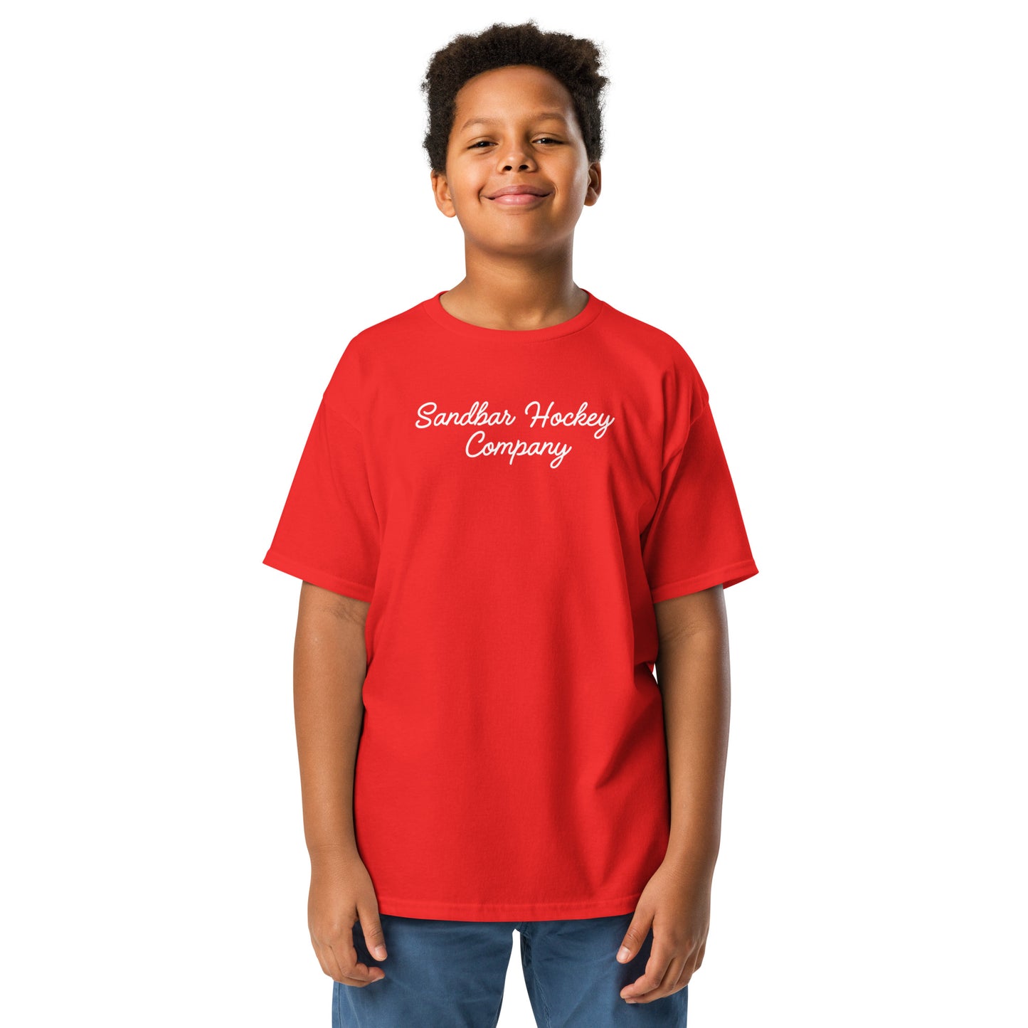 Red youth hockey t-shirt shown from the front on a child model, featuring a white Sandbar Hockey Company script logo across the front chest.