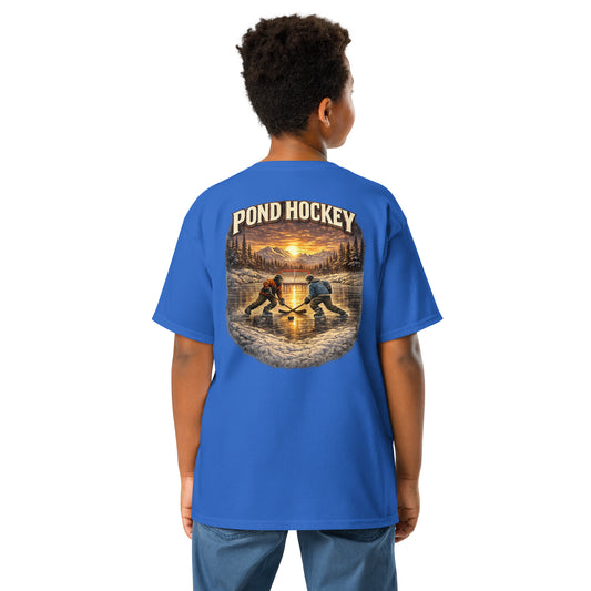 Royal blue youth T-shirt with a large back graphic showing two hockey players on a frozen pond at sunset, with mountains, pine trees, a goal net, and “POND HOCKEY” in bold lettering above.