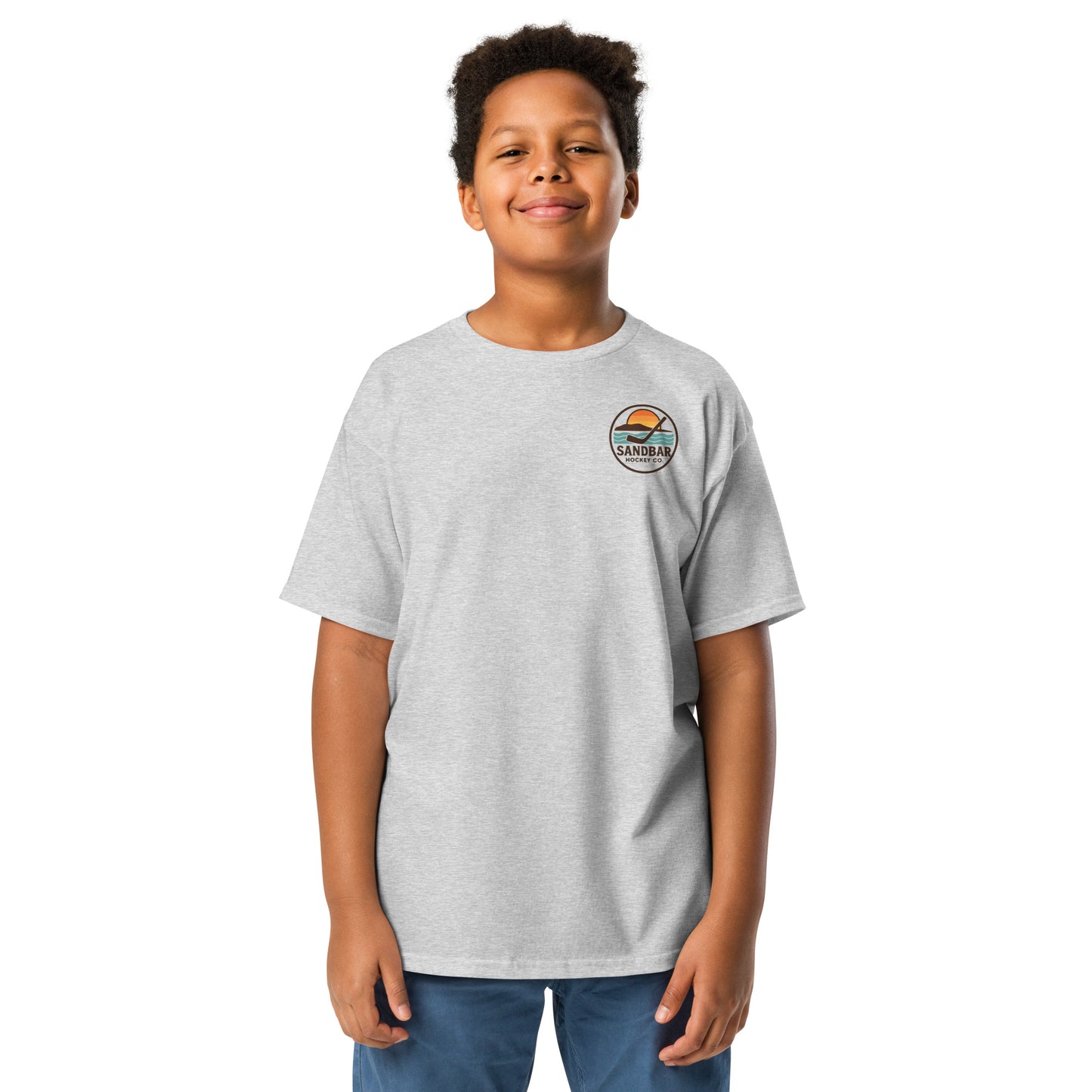 Youth grey Sandbar Hockey Dog Badge T-Shirt front view on model with small circular Sandbar Hockey Co. chest logo