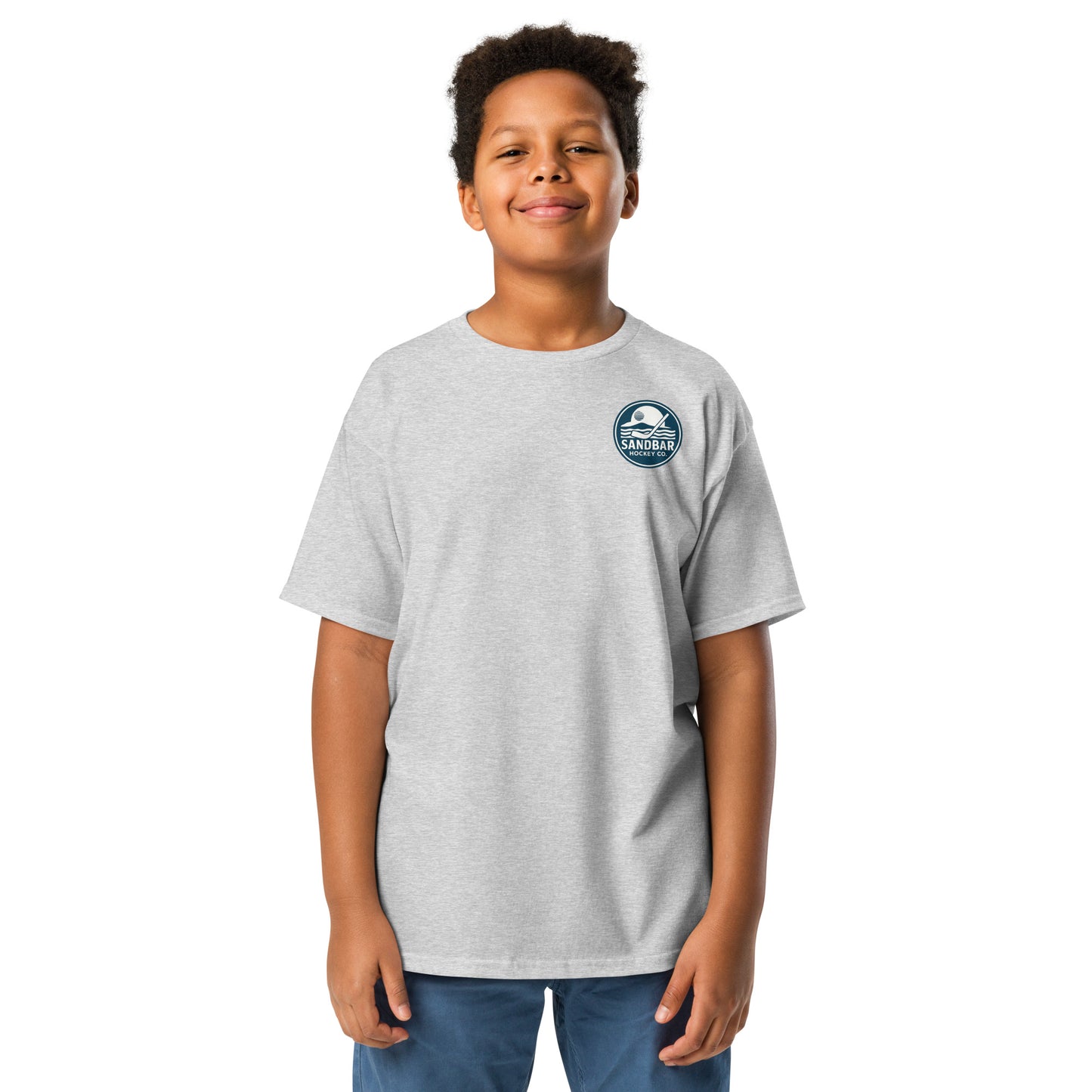 Grey Youth Fort Myers Sandbar Hockey T-shirt front view with small circular Sandbar Hockey Co. chest logo showing sunset, island, water, and a hockey stick