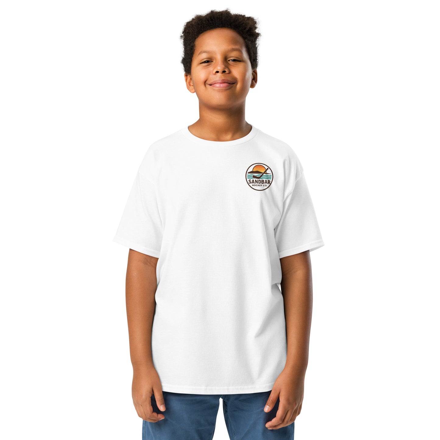 Youth white Sandbar Hockey Dog Badge T-Shirt front view on model with small circular Sandbar Hockey Co. chest logo